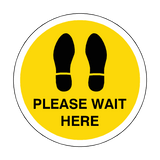 Please Wait Here Floor Sticker - Yellow | Safety-Label.co.uk