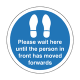 Please Wait Until Person In Front Has Moved Floor Sticker - Blue | Safety-Label.co.uk