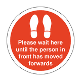 Please Wait Until Person In Front Has Moved Floor Sticker - Red | Safety-Label.co.uk